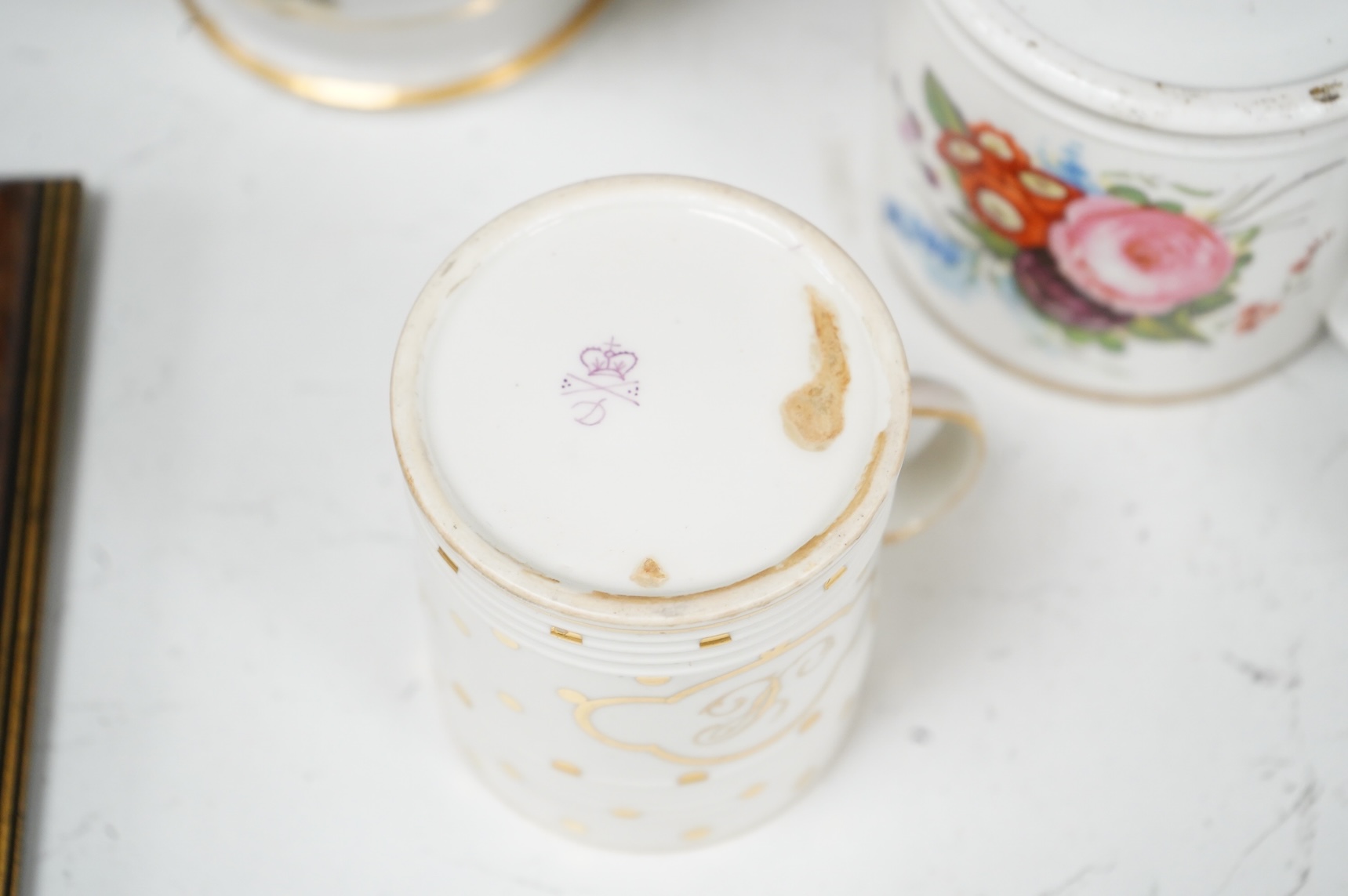 A pair of early 19th century English porcelain large mugs with gilt bands and five other early 19th century porcelain or pearlware mugs, one inscribed SG, Forget Me Not, largest each 14cm high
